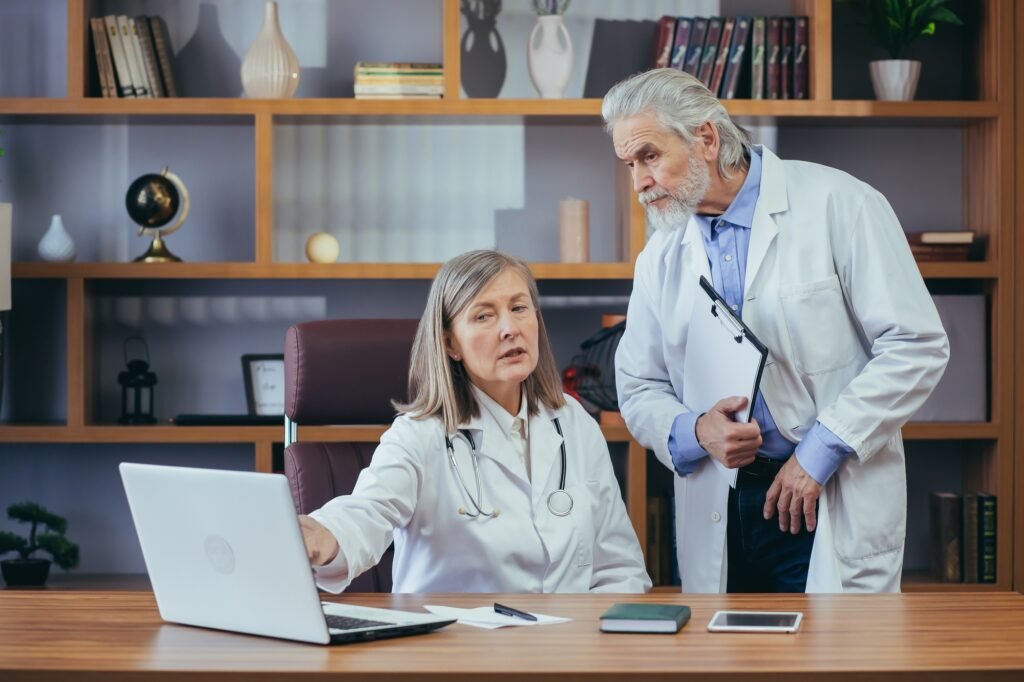 Senior doctors consult and practice in the classic office of the clinic, discuss the diagnosis of